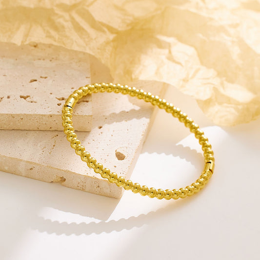 Stainless steel plated 18-karat gold bead snap bracelet