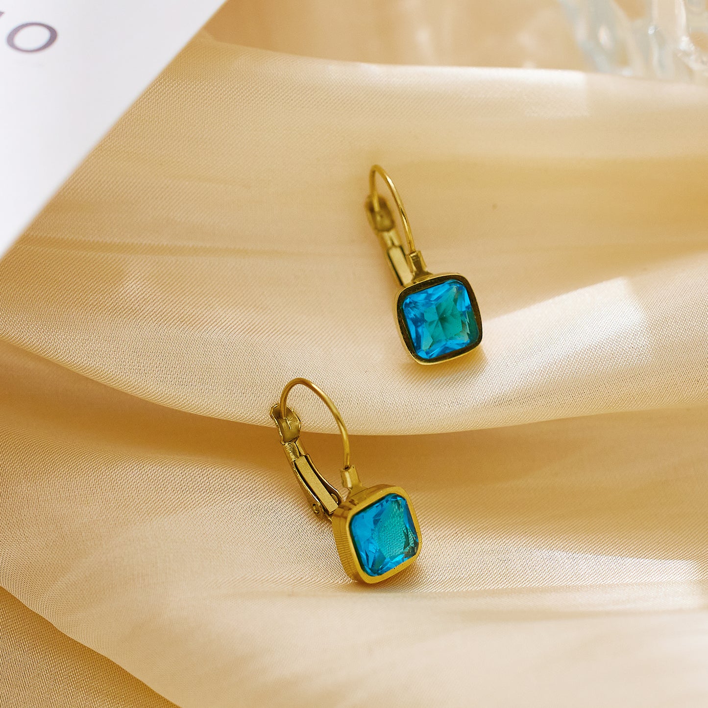 Stainless steel plated 18-karat gold with blue diamond earrings