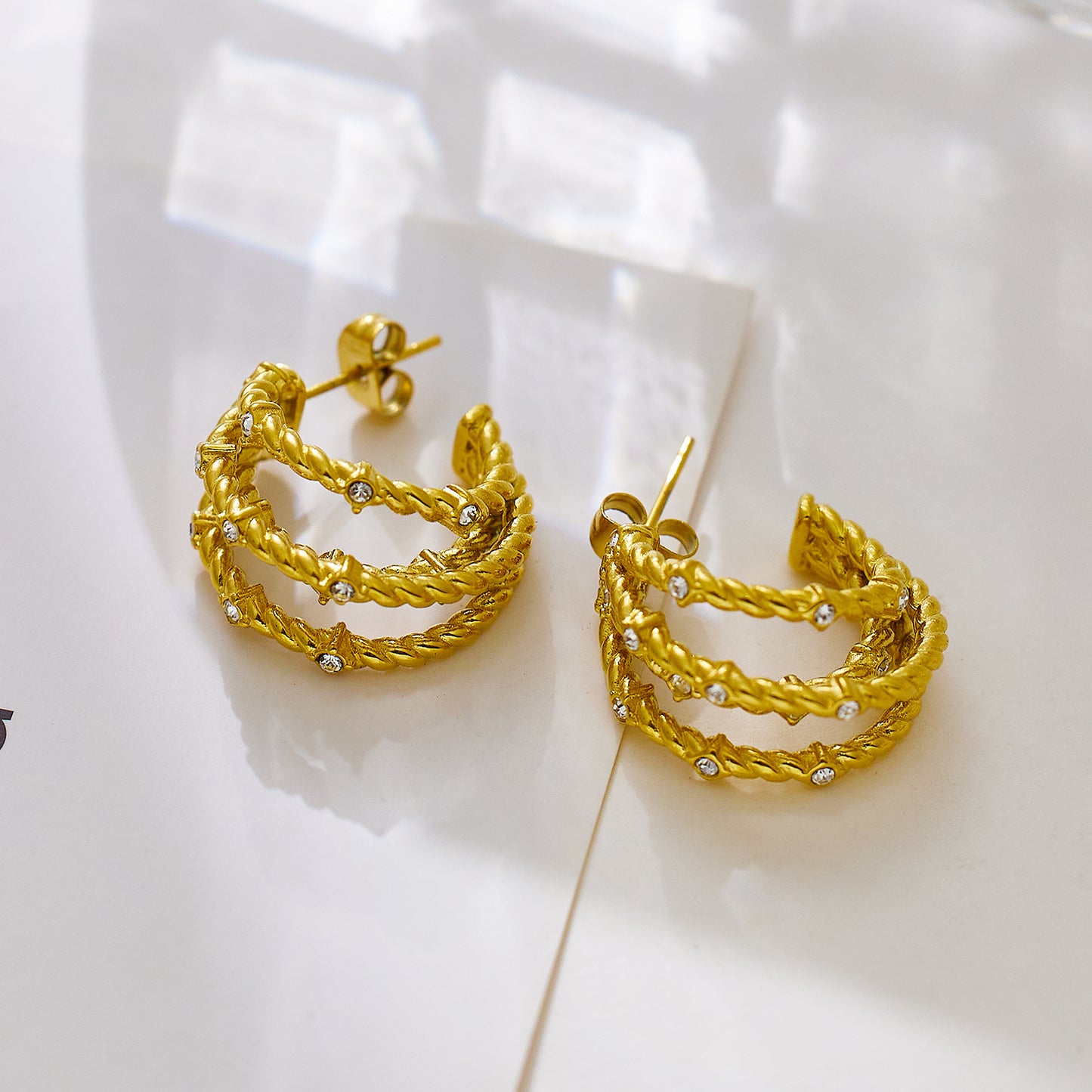 18-karat gold cord earrings in stainless steel